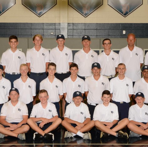The boys golf team pose for their team picture.