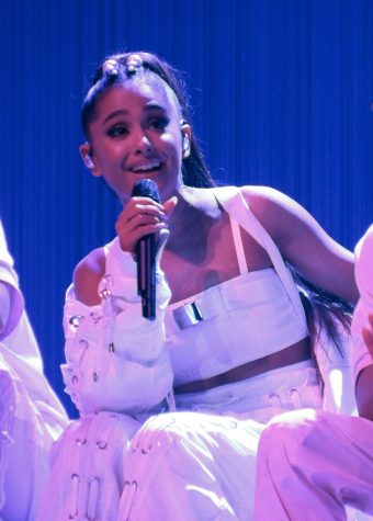 Ariana Grande sings on stage.