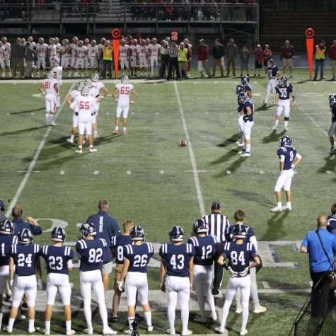 The football team sets up to run a play.