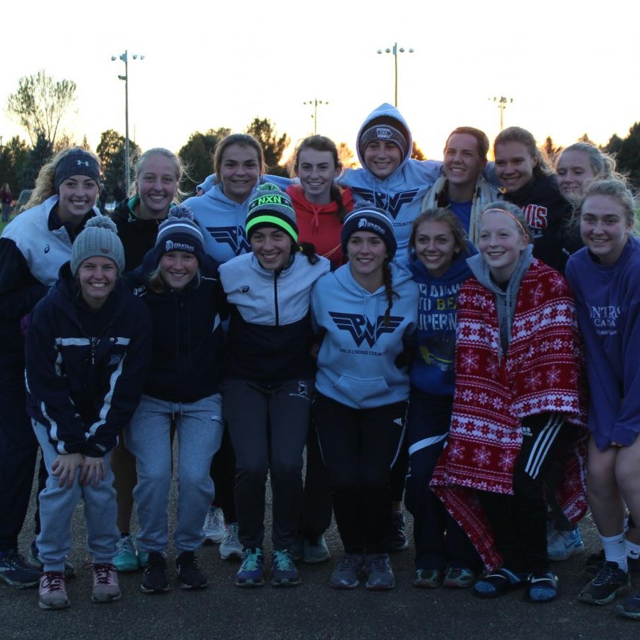 The girls cross country team poses after a meet.