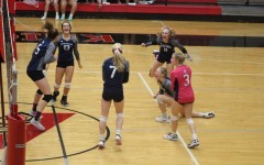 The Pleasant Valley volleyball team celebrates after winning.