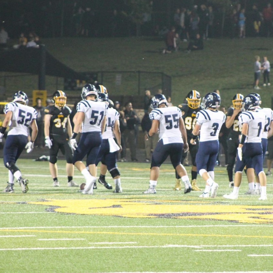 The football team lines up to run a play.
