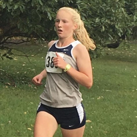 Senior Mallory Lafever runs in a cross country meet.