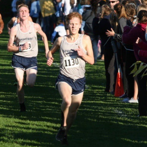 Senior Parker Huhn (right) sprints to the finish line during the district meet.