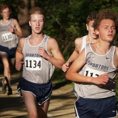 (from left to right) Senior Parker Huhn, Senior Gavin Smith, and Junior Max Murphy run the state meet.