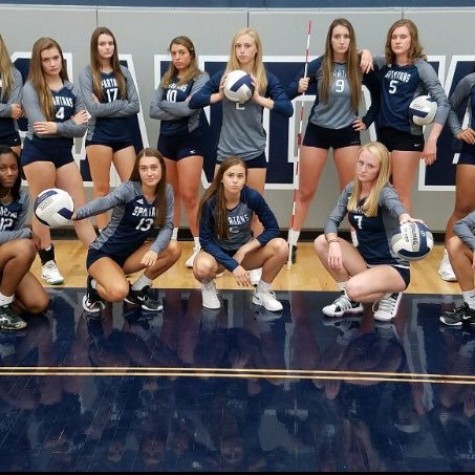 The girls volleyball team poses for a picture