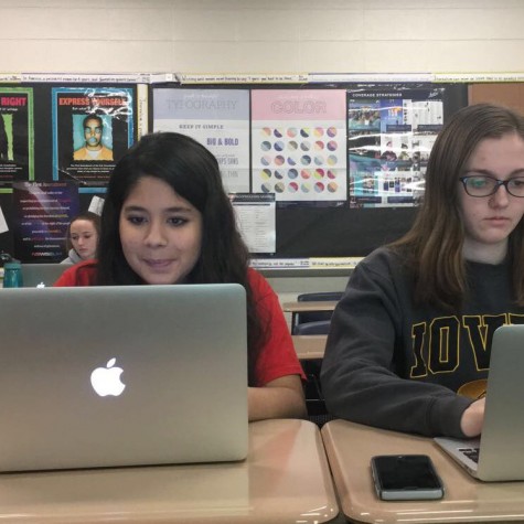 Seniors, Angela Pandit and Danielle Nauman, working on their articles for Honors Journalism.