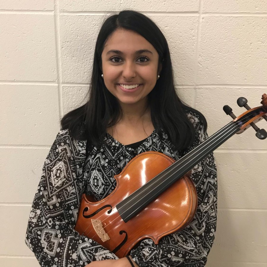 Mahum Haque poses with her viola.