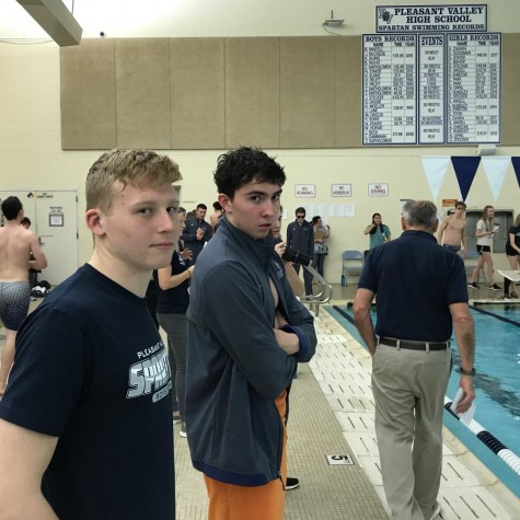 Senior captains Jacob Mccredie and Kevin Burke catch the camera as they watch their teammates swim from the sidelines. The boys swim team is in the middle of season currently and can be found racing other schools in the swimming pool at Pleasant Valley High School