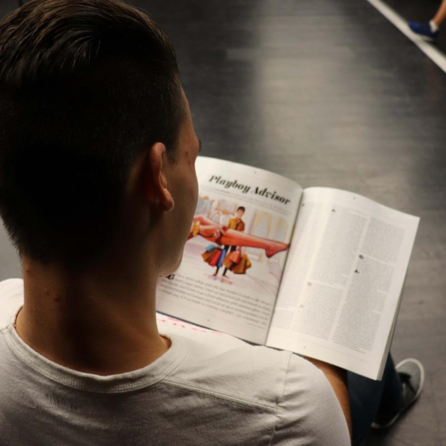 An anonymous student looks through the pages of a pornographic magazine.