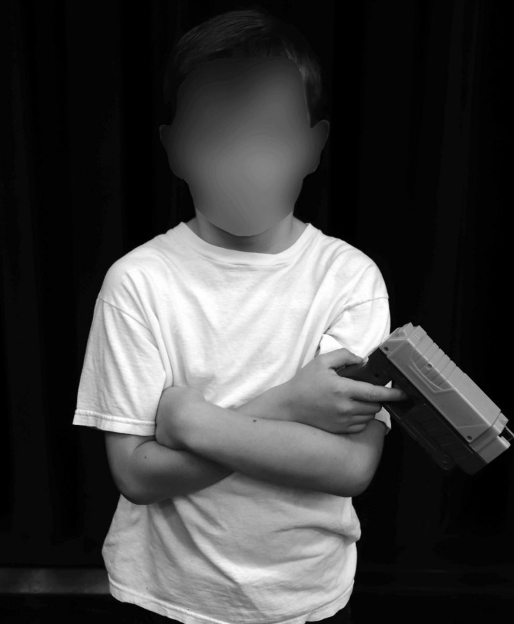 An anonymous Pleasant Valley boy poses with his toy gun.