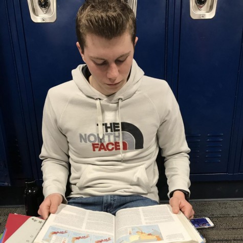 AP human geography student, Noah Streeter, reading the textbook to study for a test.
