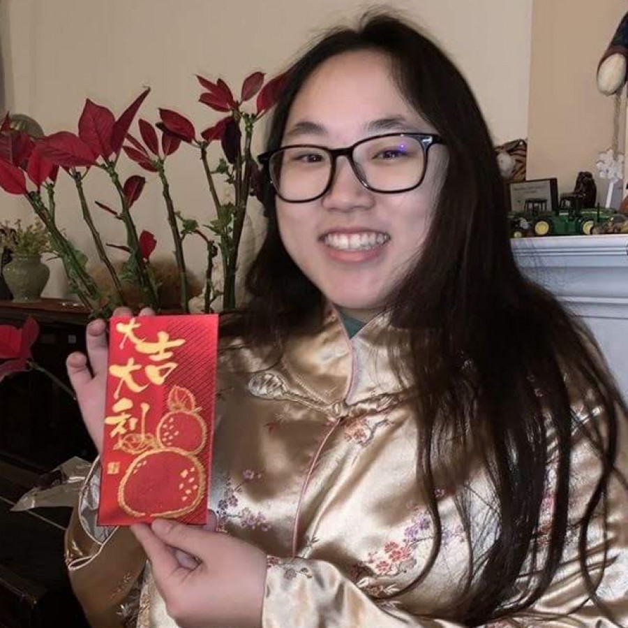 PV Junior Margaret Huang wearing traditional Chinese clothing and holding a red envelope on Lunar New Year.
