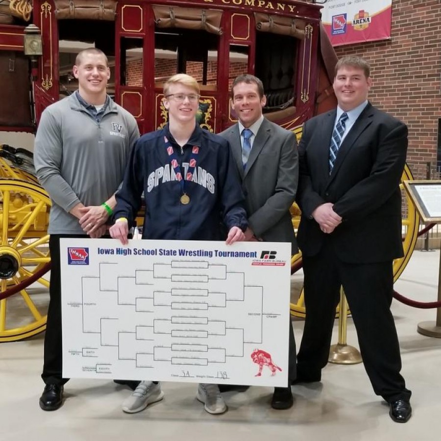 Eli Loyd poses with his first place medal and his coaches, Spencer Leuders, Jake Larsen, and Justin Fah.