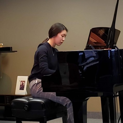 Christina Li playing the piano at a preparatory recital for a competition. 