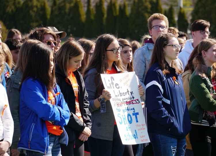 Students standing on Pleasant Valley’s football field participating in the National School Walkout on April 20, 2018.
