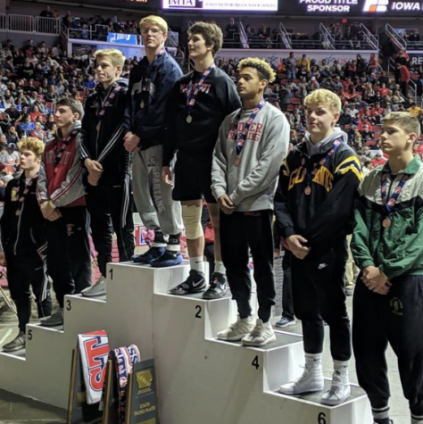 Eli Loyd with his fellow competitors after winning first place at the state wrestling tournament in Des Moines. 

