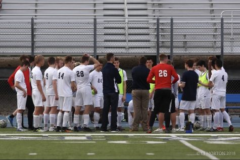 The Pleasant Valley boys varsity soccer team gathering together during a game in 2018. 