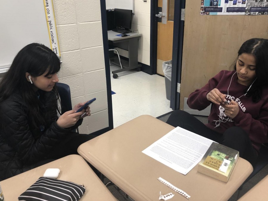 Freshmen Alissa Pandit and Aayusha Adhikari search for music to listen to in order to wind down after a long school day