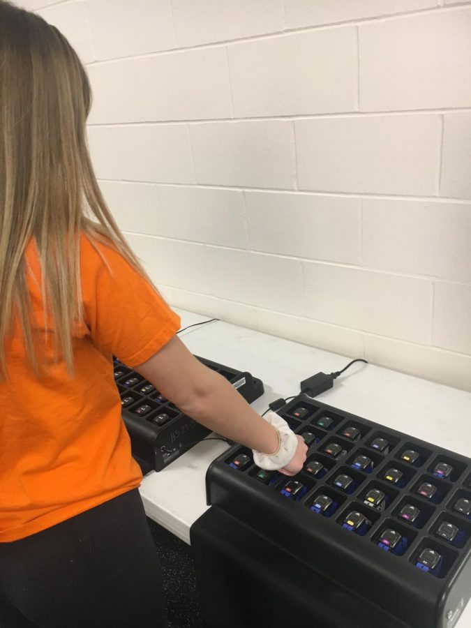 Sophomore, Jordyn Edwinson, checking out her assigned heart rate monitor before gym class.
