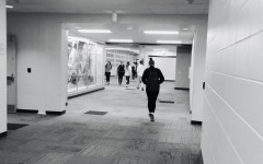 Students and teachers walk between the old building and the new edition which was opened this year.  
