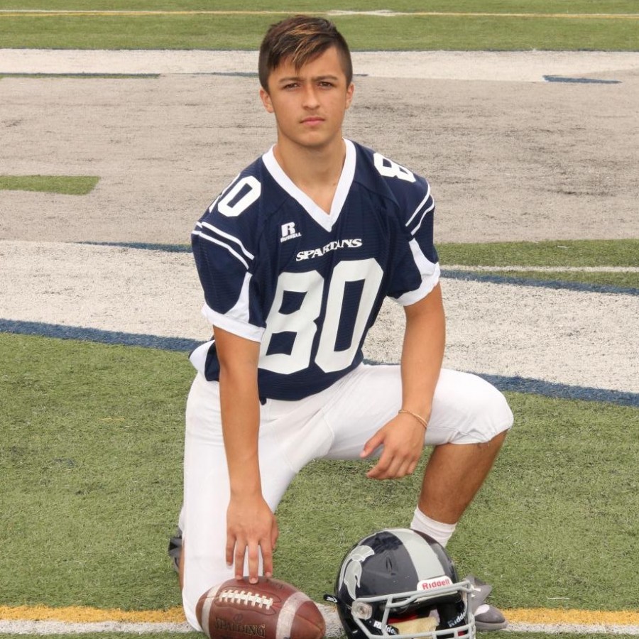 Zach+Ngo+is+posing+for+his+sophomore+year+football+team+picture.+