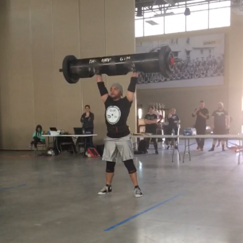 David Baxter competing in the log clean and press event, pressing 230 lbs.
