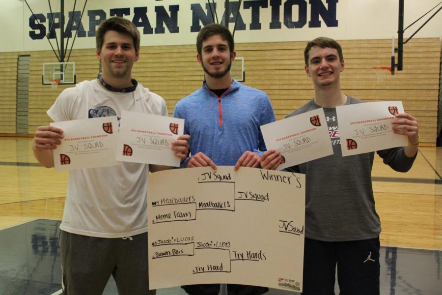 Brett Ahlgren, Hunter Snyder, and Carter Duwa (left to right) pose with their awards after winning the 3v3 basketball championship. 
