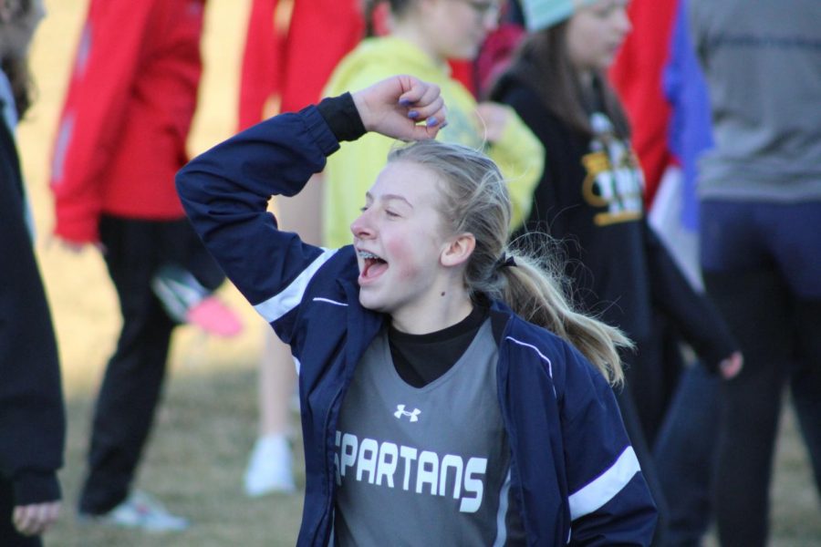 Freshman, Summer Halsey shows her excitement for her fellow teammates race.