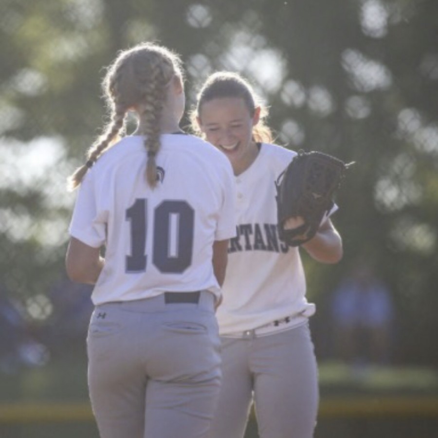 Ellie+and+Carli+Spelhaug+celebrate+together+after+a+conference+play+win+in+June+of+2018.+The+two+athletes+went+on+to+lead+their+team+in+becoming+back-to-back+state+champions.++