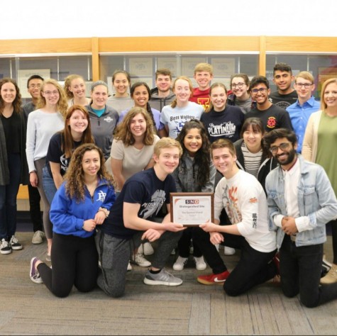 The second semester honors journalism class accepting the Best of SNO award of distinguished site.