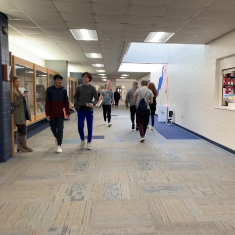 Students walk down the main hallway of Pleasant Valley High school, next to the library and a school materials room. These are both excellent studying spaces and materials for PV students.