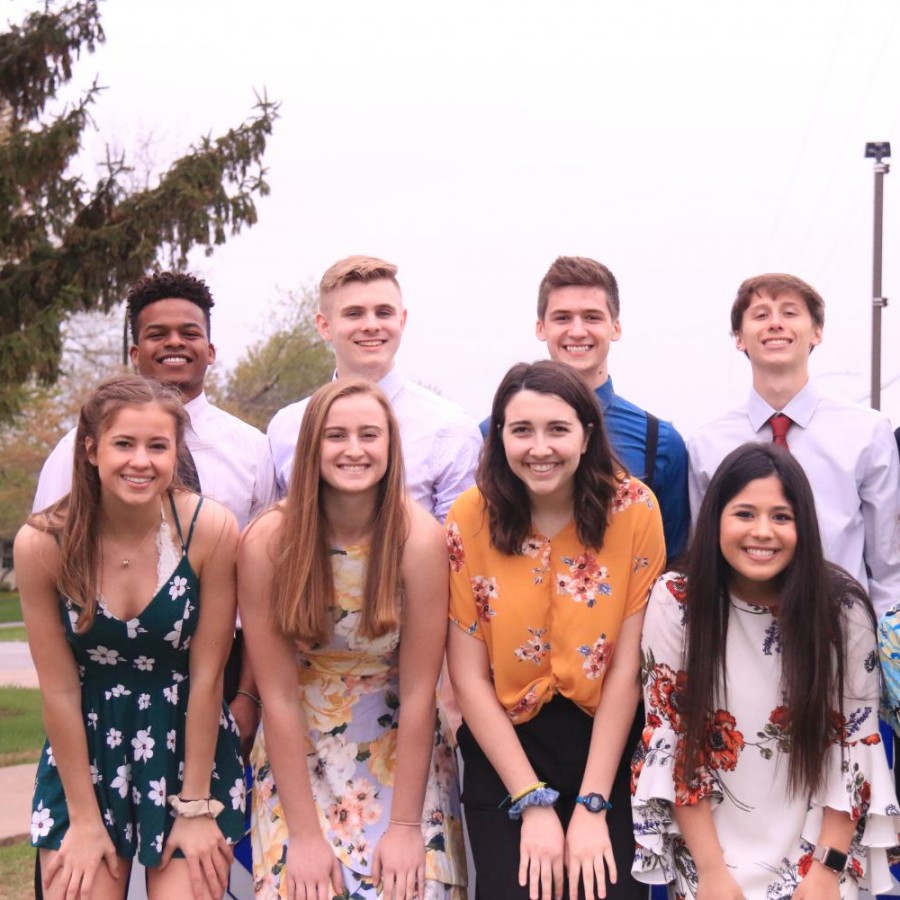 The 2019 Prom Court poses for a photo in front of the Pleasant Valley High School sign.