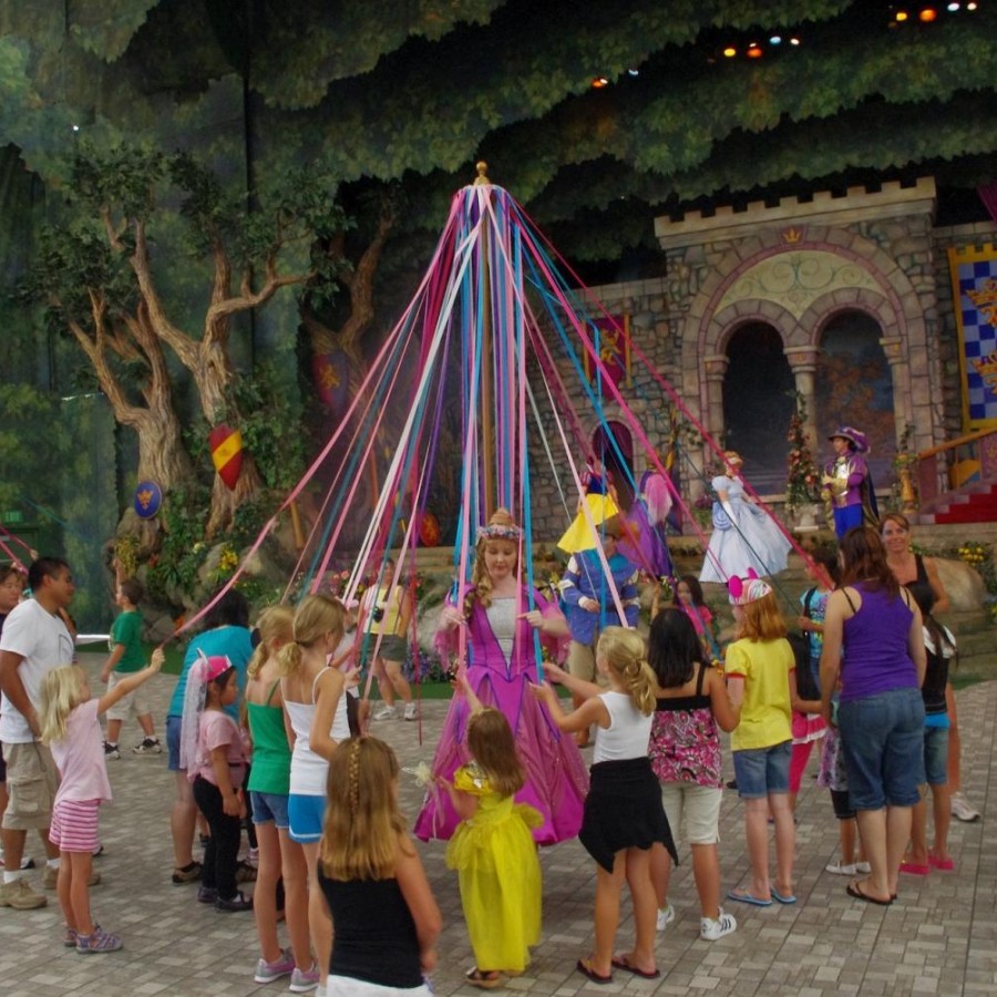 In+celebration+of+May+Day%2C+young+children+dance+around+the+maypole+with+brightly+colored+ribbons+attached.+%0A