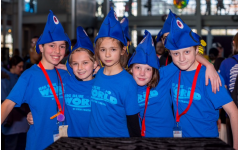 Big Blue World members sport both team shirts and smiles while at a robotics competition.