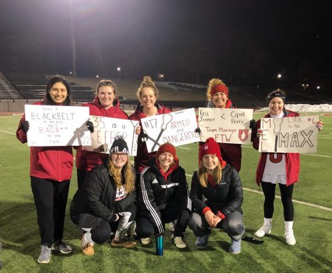 Kate Mickle, bottom left, and fellow students at Monmouth College enjoying their time at a college lacrosse game.