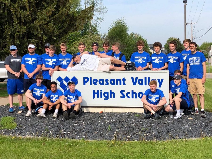 The boys' track and field team gathered around the PVHS sign prior to leaving for the state meet.