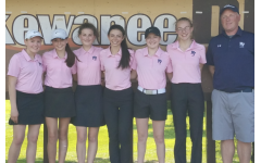 The girls golf team stands by Coach Kingrey at the MAC meet