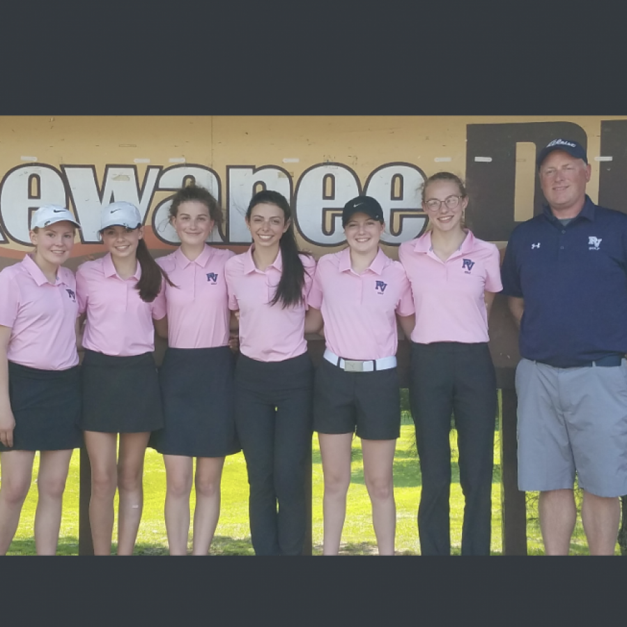 The girls golf team stands by Coach Kingrey at the MAC meet