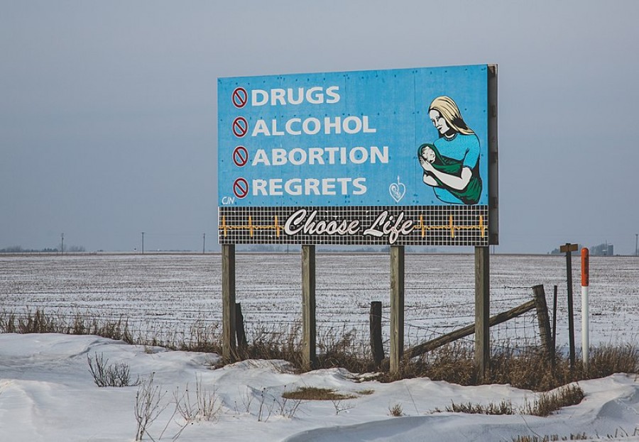 A billboard depicting pro-life ideas stands beside a highway in Pella, Iowa.