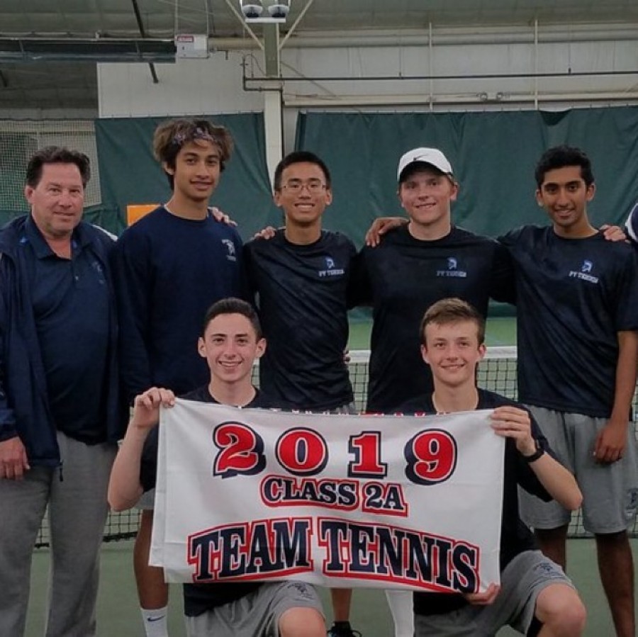 The+Pleasant+Valley+boys%E2%80%99+tennis+team+holds+their+banner+after+claiming+the+district+title.+