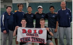 The Pleasant Valley boys’ tennis team holds their banner after claiming the district title. 