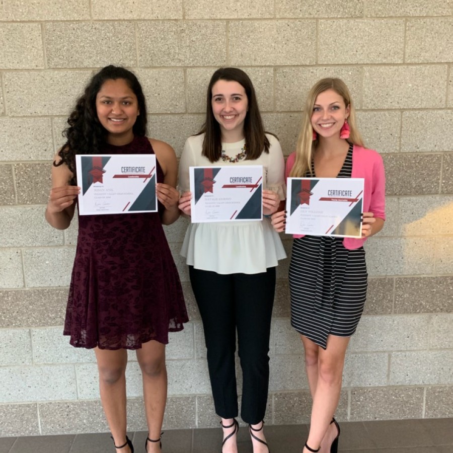 Pleasant Valley seniors, (from left to right) Susan Anil, Natalie Murphy, and Lily Williams hold up the certificates presented to them at the Quad City Times Salute to Academics and Achievements. 
