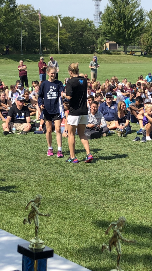 Bella D’Antico receiving her 17th place award from coach Jane Wheeler at the Spartan Challenge on Sept 7. 