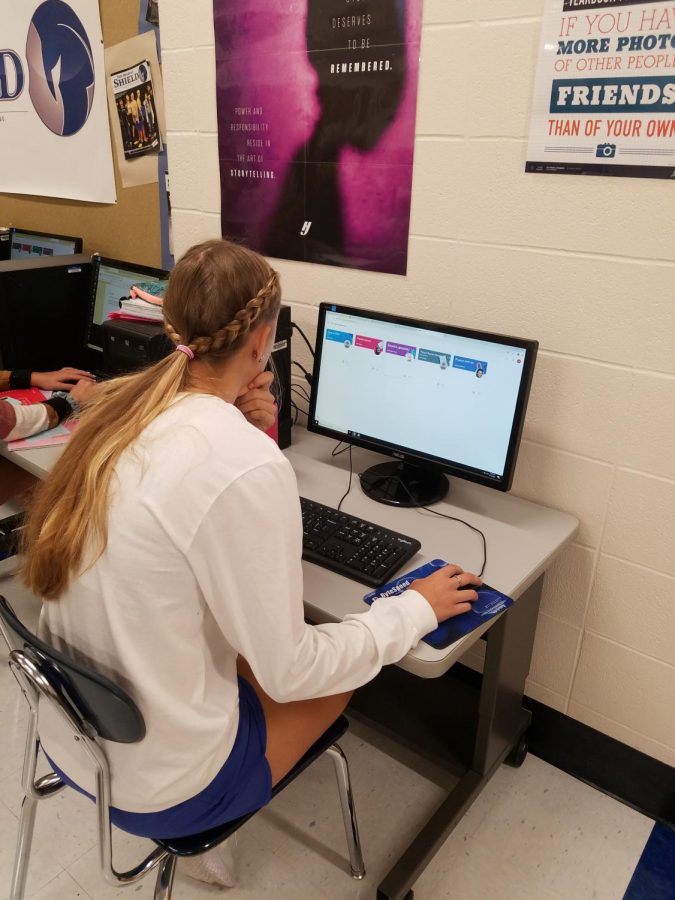 A student looks at her Google Classroom for upcoming assignments.
