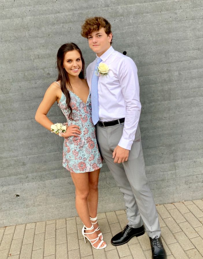 Julia Necker (20) pictured with Logan Colliar (20), wearing her light blue and floral homecoming dress. 