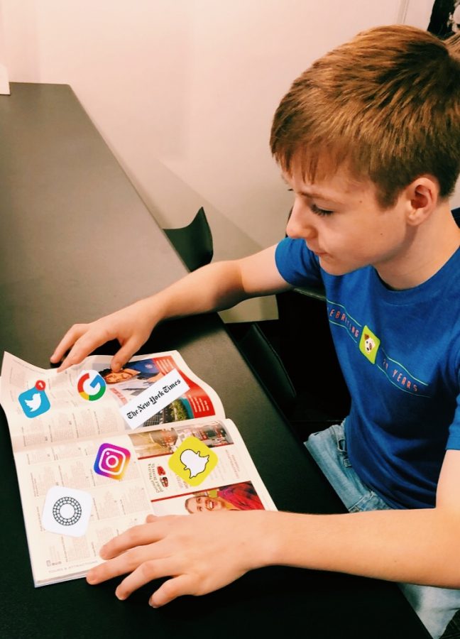 Senior Cole Huber opens a book to read, but is presented with many things to do on the internet. 