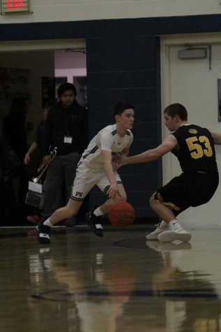 Sophomore Ryan Dolphin dribbles past Bettendorf Senior Joe Byrne in last year’s rivalry game at PV.