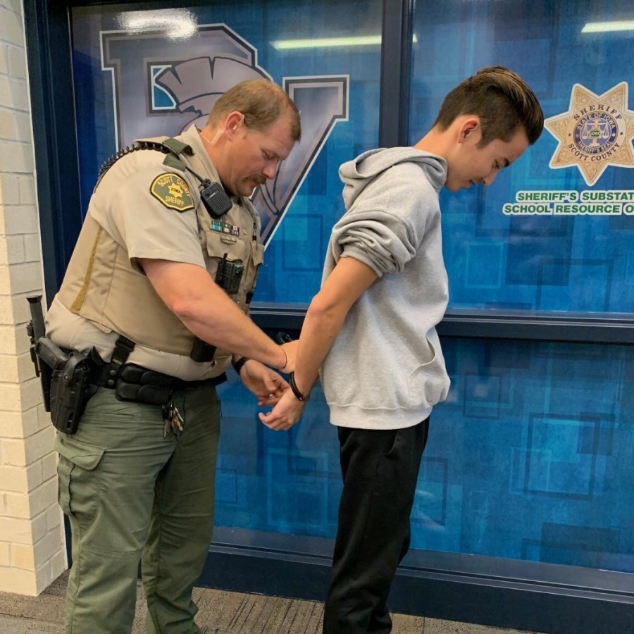 Deputy Jamey Fah demonstrates his handcuffing technique in front of his PVHS office. He reminds students that becoming a legal adult at age 18 means more serious legal consequences if a law is broken. 