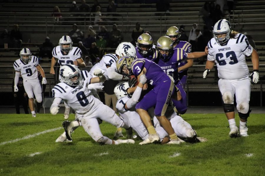 Seniors Brandon Young and Jose Lara tackle a Muscatine player during their October 4th game.